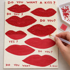 Diamond painting process for playful red lip motifs with a kiss message.
