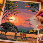 Making the Evening Watchers diamond painting, with hands placing drills over quiet watchers beneath dark trees at sunset over layered mountains.
