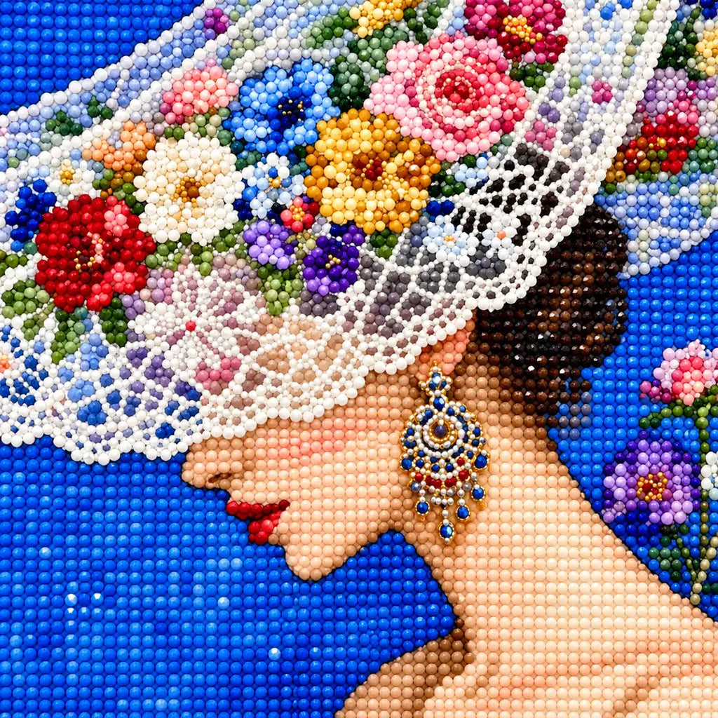 Close-up diamond drill detail of the bride’s floral brim, veil, and profile