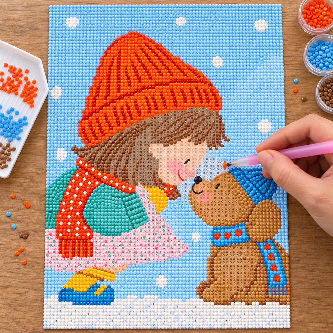 Diamond painting process showing a girl and bear winter scene being completed with a stylus