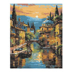 Finished diamond painting of boats and old-town buildings reflected in a golden canal at sunset.
