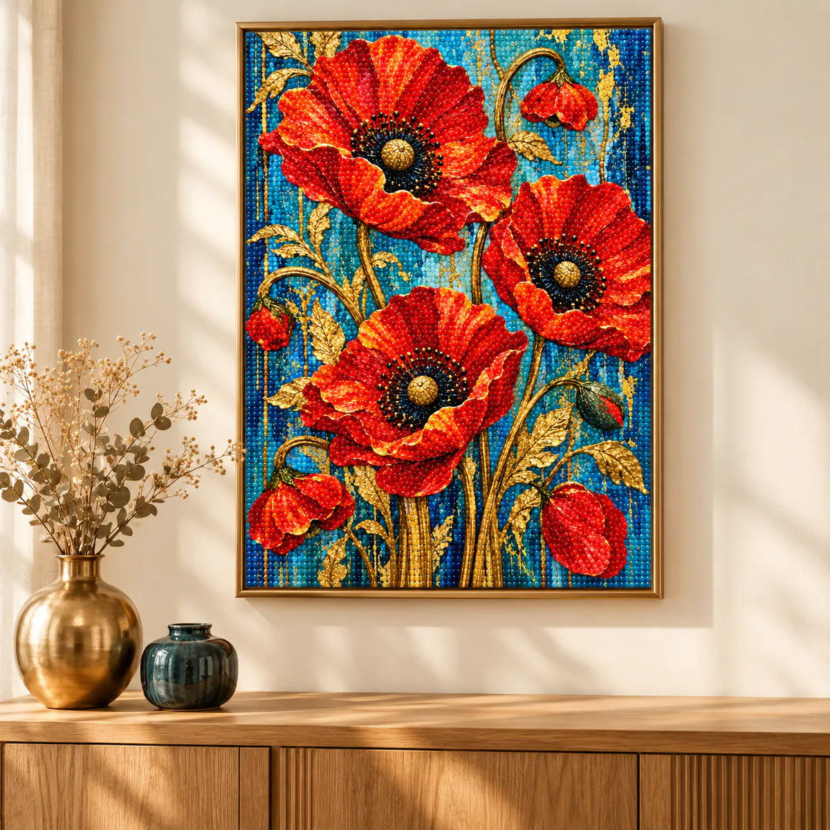 Home decor scene showing golden stems and scarlet blooms displayed on a wall.