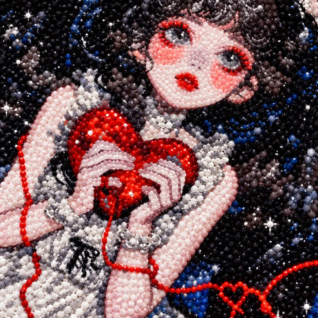 Close-up diamond drill detail of a gothic girl holding a red heart