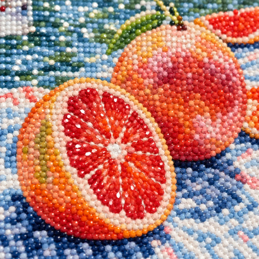 Close-up of diamond drill details in a grapefruit picnic scene beside a flowing river.