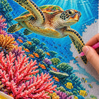 Hands placing diamond drills on the Great Barrier Reef Turtle design.