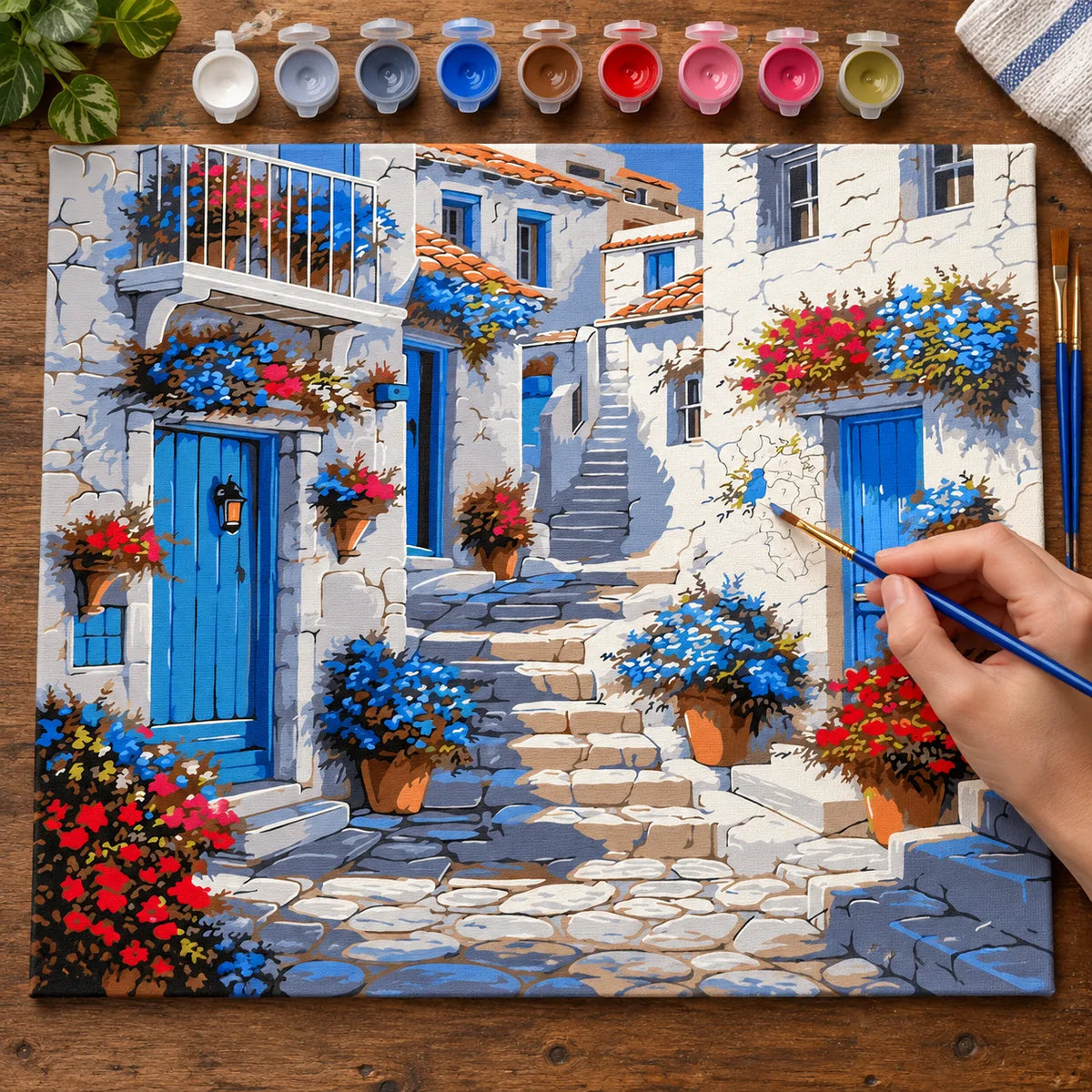 Complete Greek Blue Door Village numbered canvas being painted with acrylic paints and brushes
