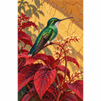 Finished diamond painting of a green hummingbird among scarlet leaves
