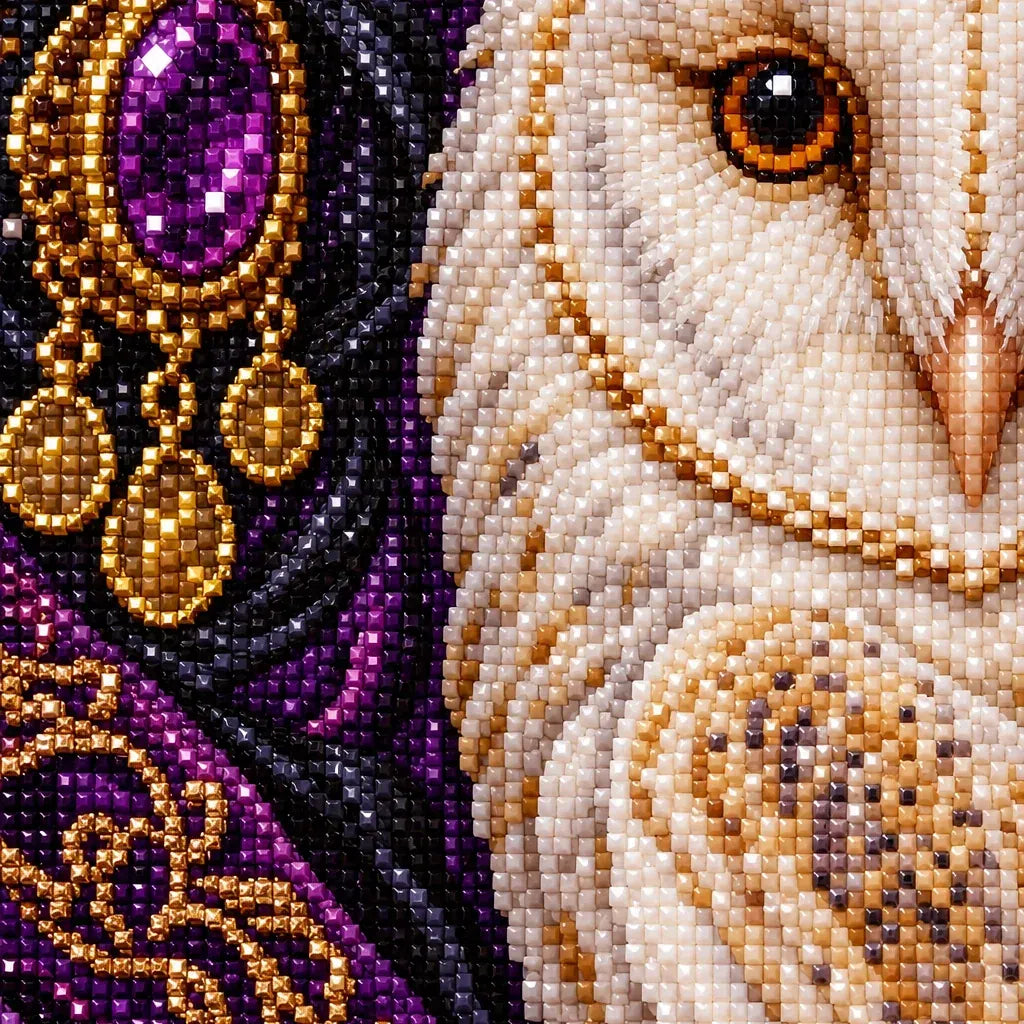 Close-up of sparkling drills across the white owl and jeweled portrait.