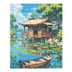 Finished diamond painting of a wooden cabin and rowboat beside a calm tree-lined lake.