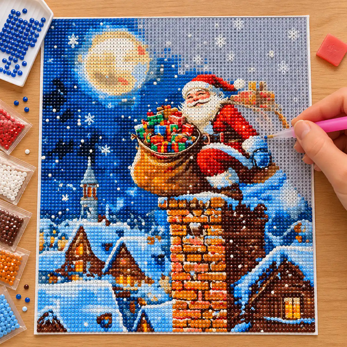 Diamond painting process for a moonlit Santa delivery scene.