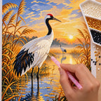 Diamond painting process for Morning Grace by the Marsh, with drills being placed over a white heron standing in reeds beneath a warm sunrise sky.
