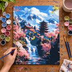 Complete Mountain Pagoda and Cherry Blossom Waterfall numbered canvas being painted with acrylic paints and brushes