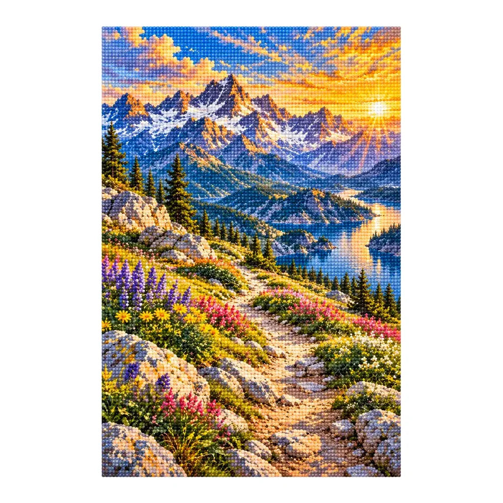 Finished diamond painting of a flower-lined mountain trail, alpine lake, and peaks on a white background.