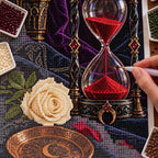 Hand placing diamond drills on the hourglass and ivory rose canvas