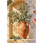 Olive branches with green and purple olives in a terracotta urn inside a sunlit arched niche: diamond painting in progress with a pen