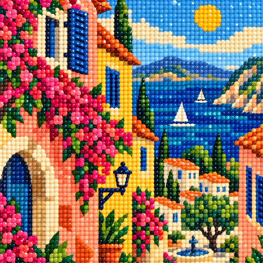 Close-up diamond drill detail of pink flowers, village rooftops, and blue coastal scenery in the artwork