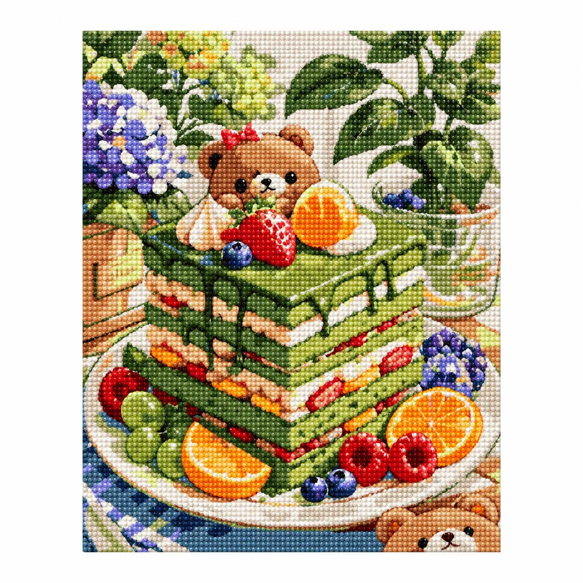 Finished diamond painting showing a bear enjoying fruit beside a matcha layer cake in a leafy picnic setting.