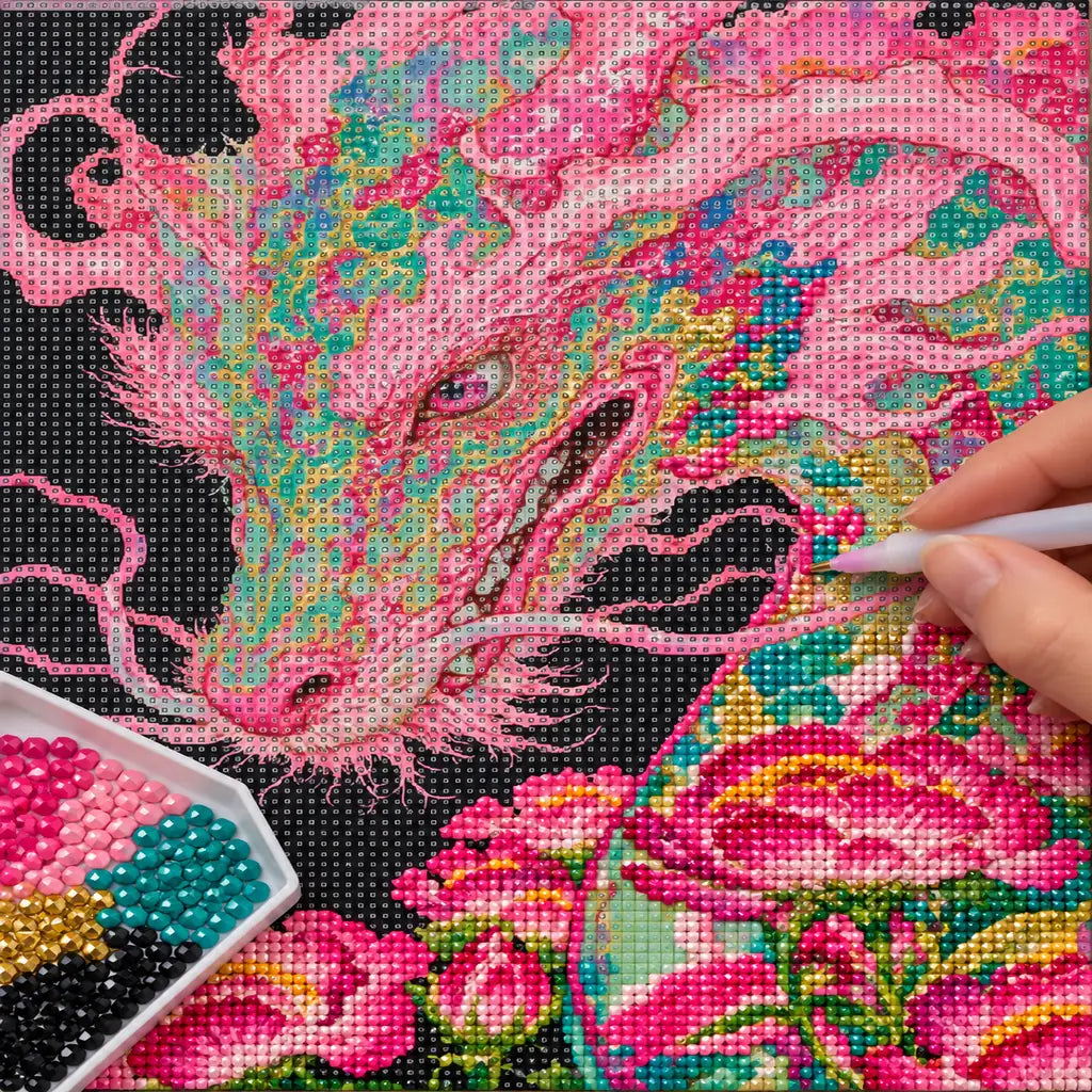 A hand placing drills on a pink dragon and peonies diamond painting canvas