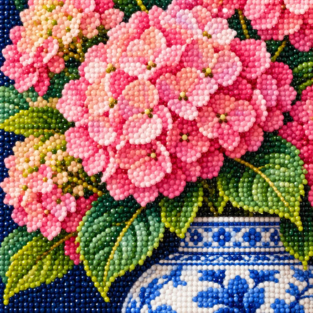 Pink hydrangeas arranged in a blue and white ginger jar: close-up of diamond drills