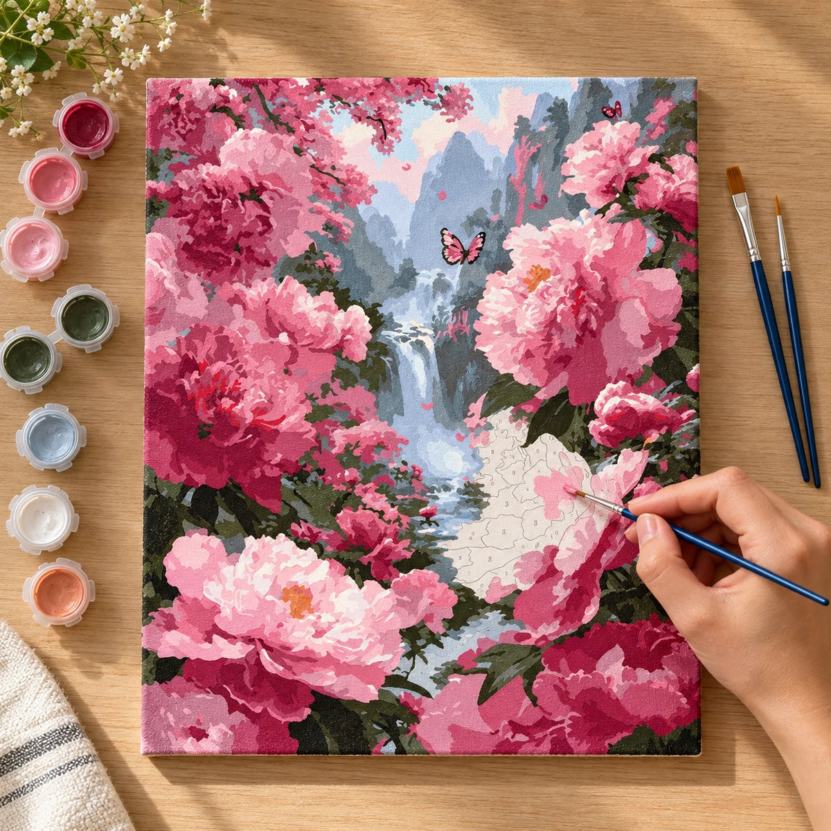 Complete Pink Peony Waterfall Garden numbered canvas being painted with acrylic paints and brushes