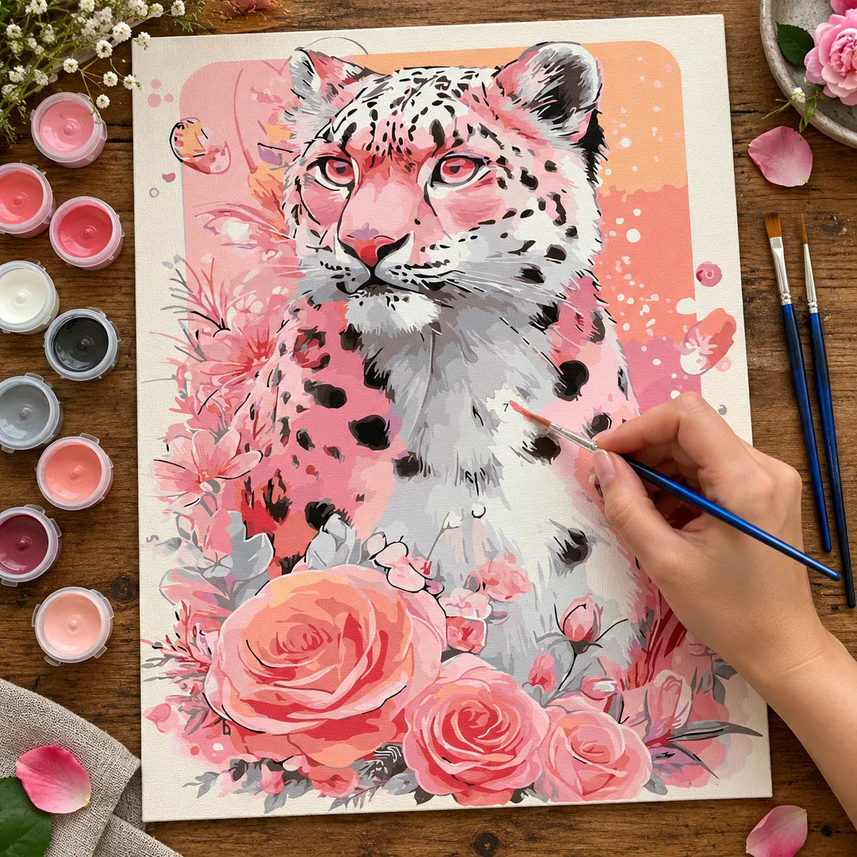 Complete Pink Snow Leopard with Roses numbered canvas being painted with acrylic paints and brushes