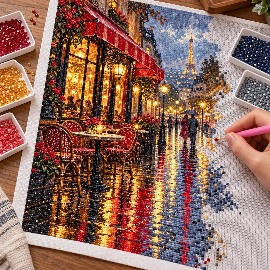 Hands placing diamond drills on the Rainy Paris Cafe design.