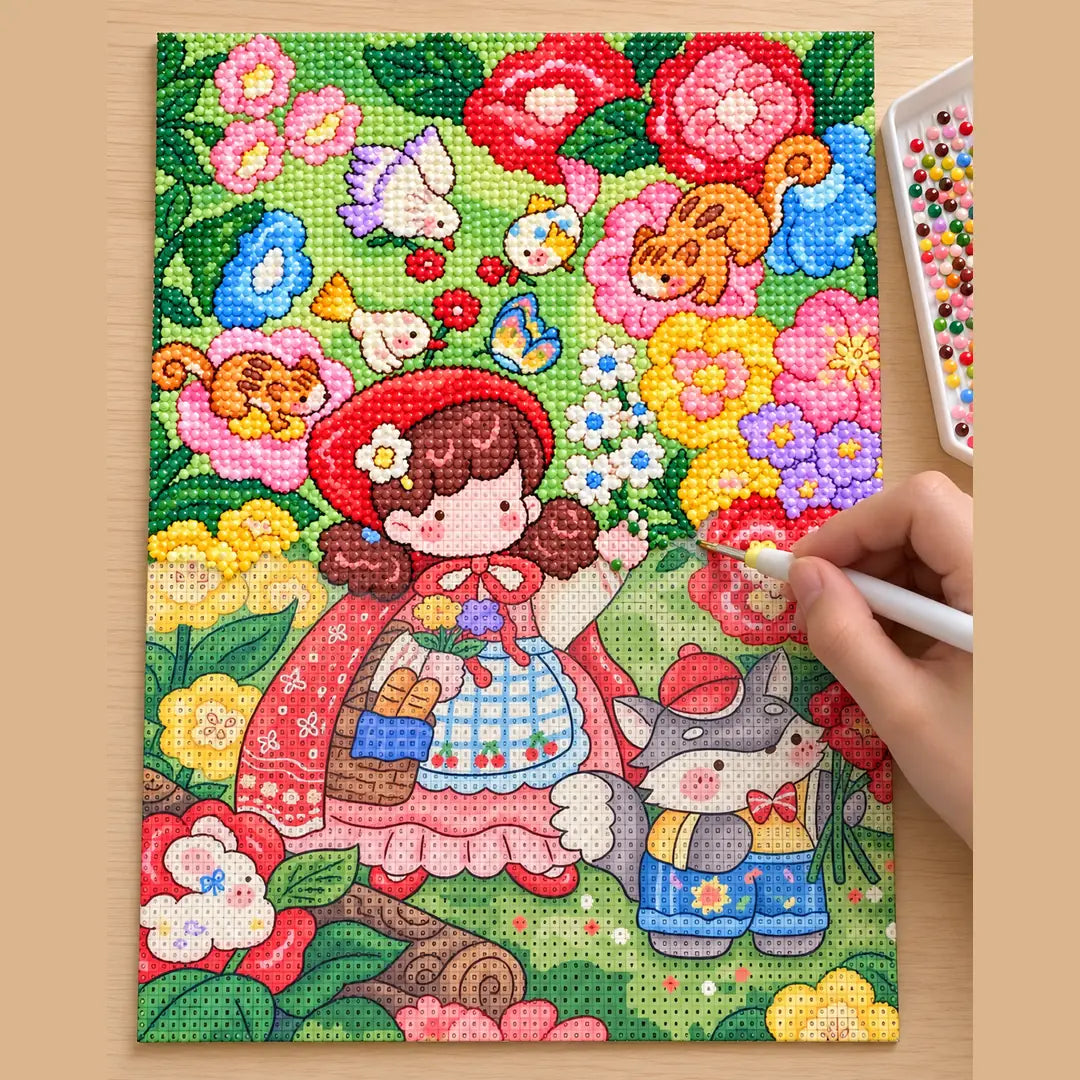 Diamond painting process showing a red riding hood girl and rabbit being completed with a stylus