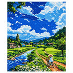 Finished diamond painting of a cyclist riding through green fields beside a stream.