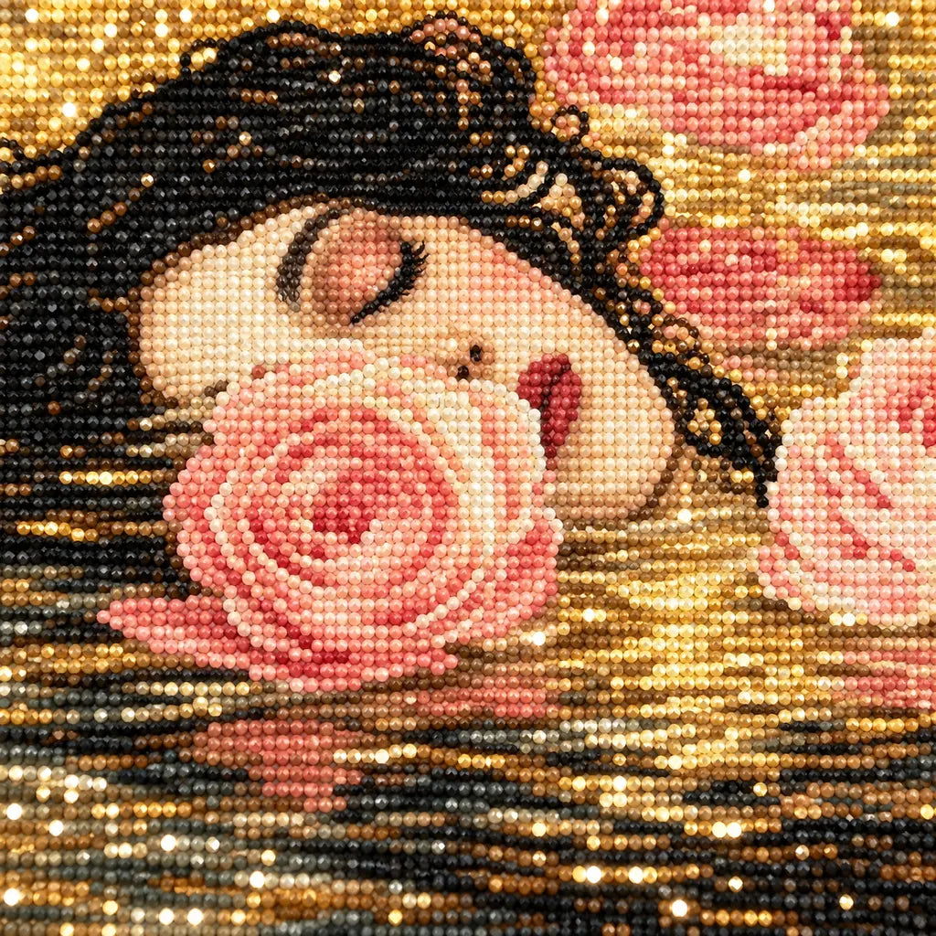 Close-up of diamond drills on artwork of a woman's face resting among floating roses in dark water.