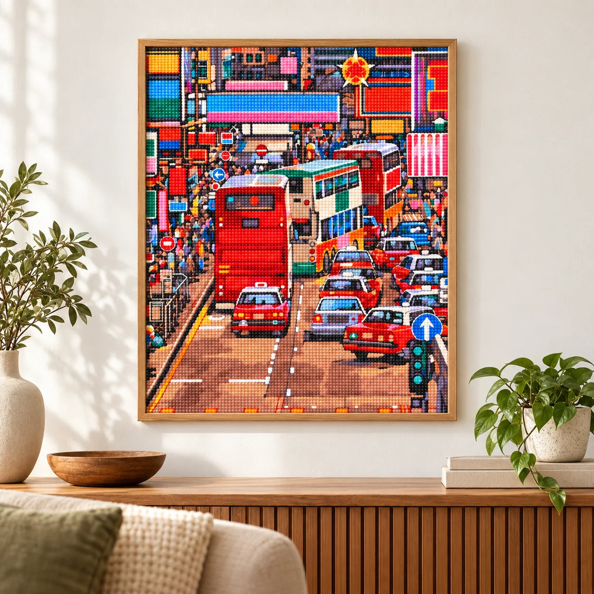 Home decor scene featuring a diamond painting of a busy Kowloon street with red double-decker buses and dense city traffic.