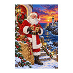 Finished diamond painting of Santa delivering a gift beside a lighthouse at sunset