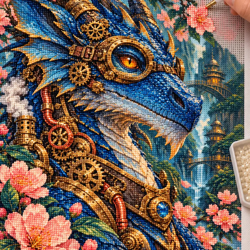 Diamond painting process showing a sapphire blue jeweled dragon with golden clockwork details and pink blossoms being completed with a stylus