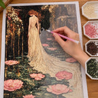 Hands applying drills to a canvas with a woman in a flowing gown beside pink lotus flowers.