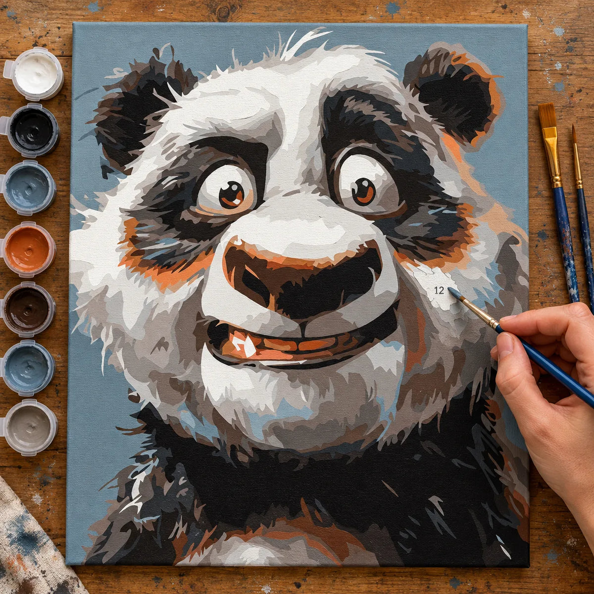 Complete Smiling Panda Portrait numbered canvas being painted with acrylic paints and brushes