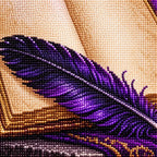 Close-up of diamond drills along the raven feather and open book.