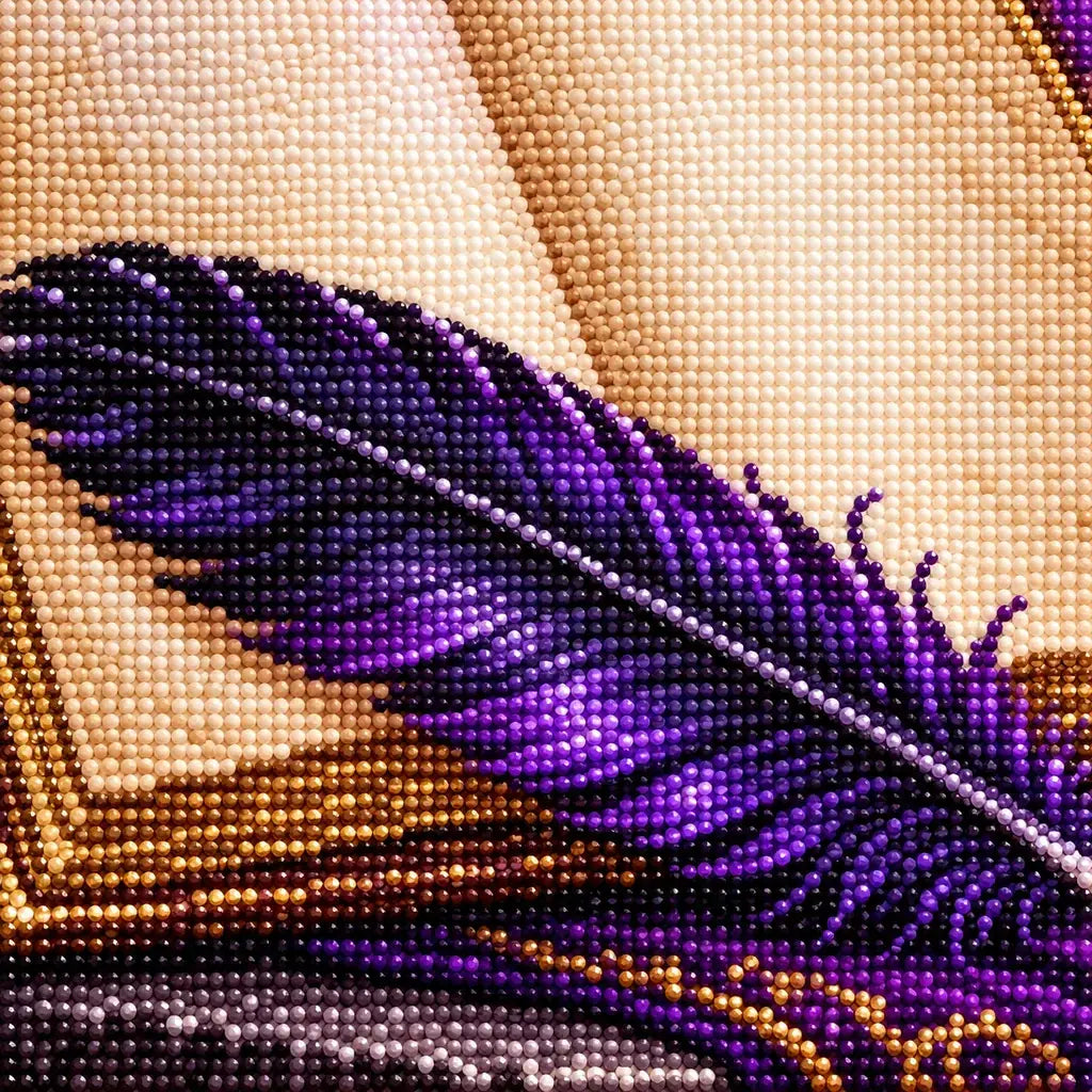 Close-up of diamond drills along the raven feather and open book.