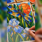 Hands placing drills on the dragonfly and iris diamond painting canvas.