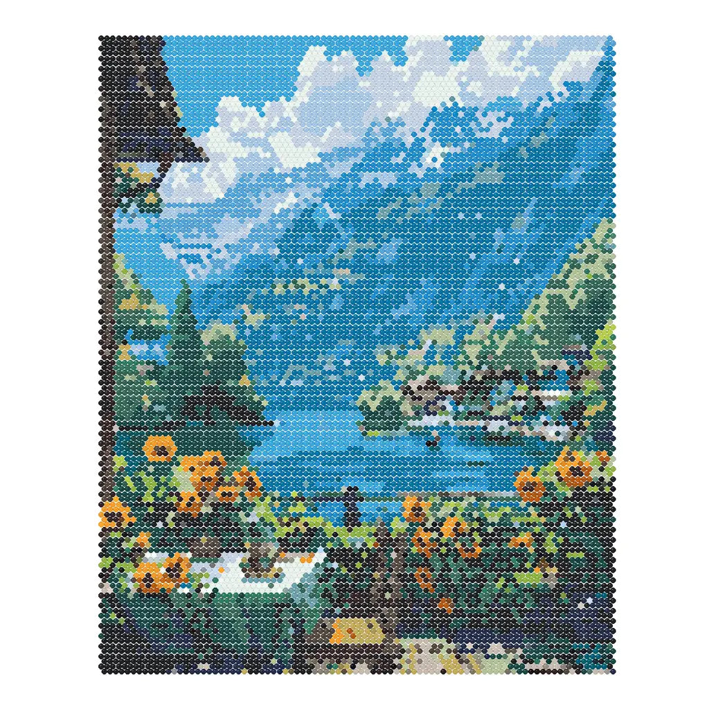 Finished diamond painting of golden sunflowers beside a blue mountain lake and distant village.