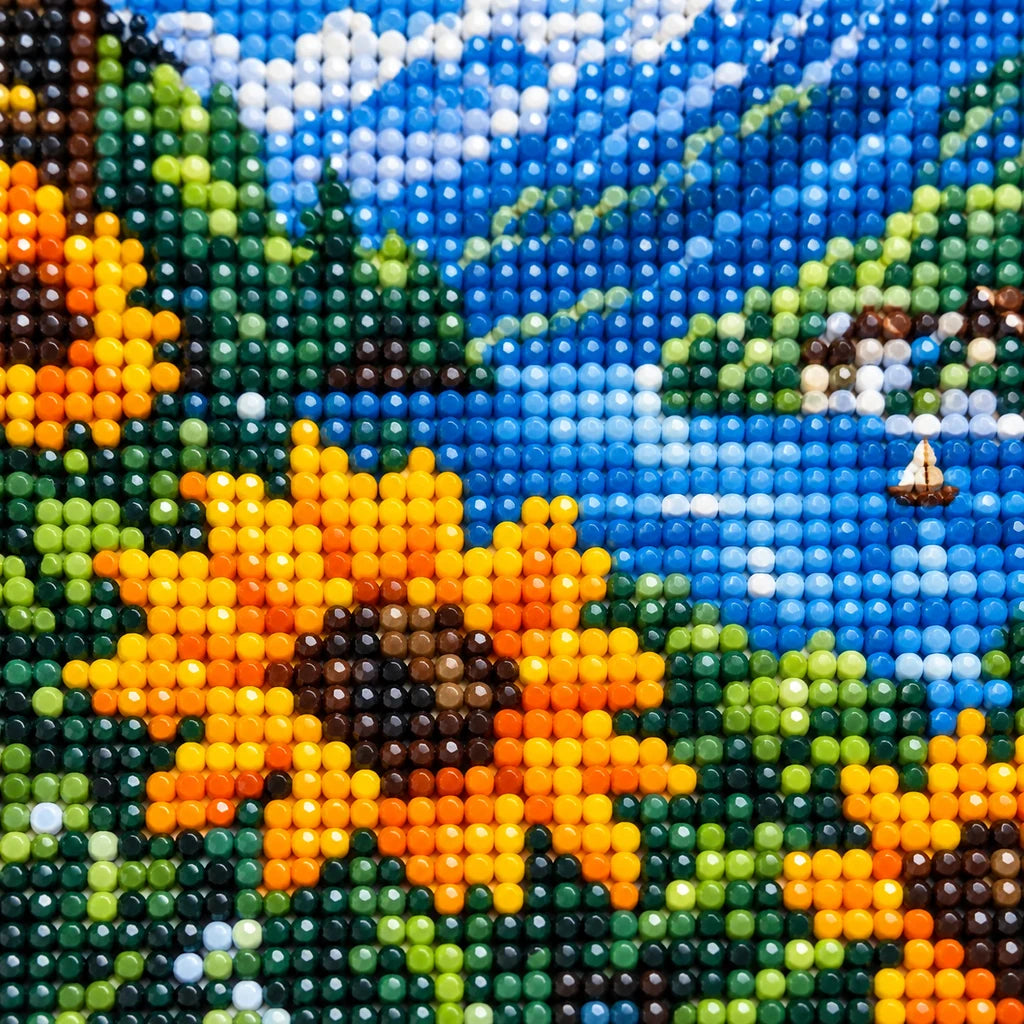 Close-up of drill texture and color in golden sunflowers beside a blue mountain lake and distant village.