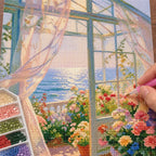 a hand placing diamonds on a sunlit glass door ocean garden — process image, diamond painting kit