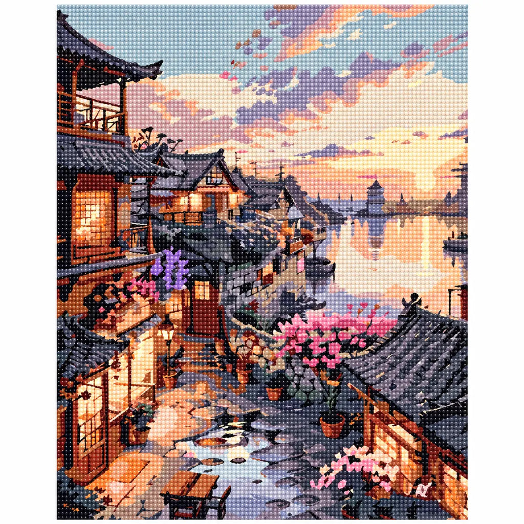 Finished diamond painting of sunset over riverside village.