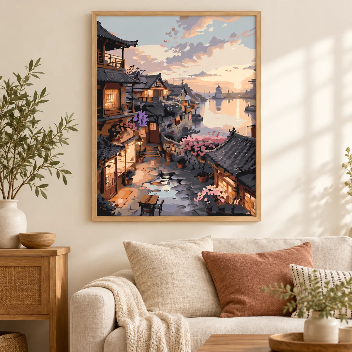 Home decor scene showing sunset over riverside village displayed on a wall.