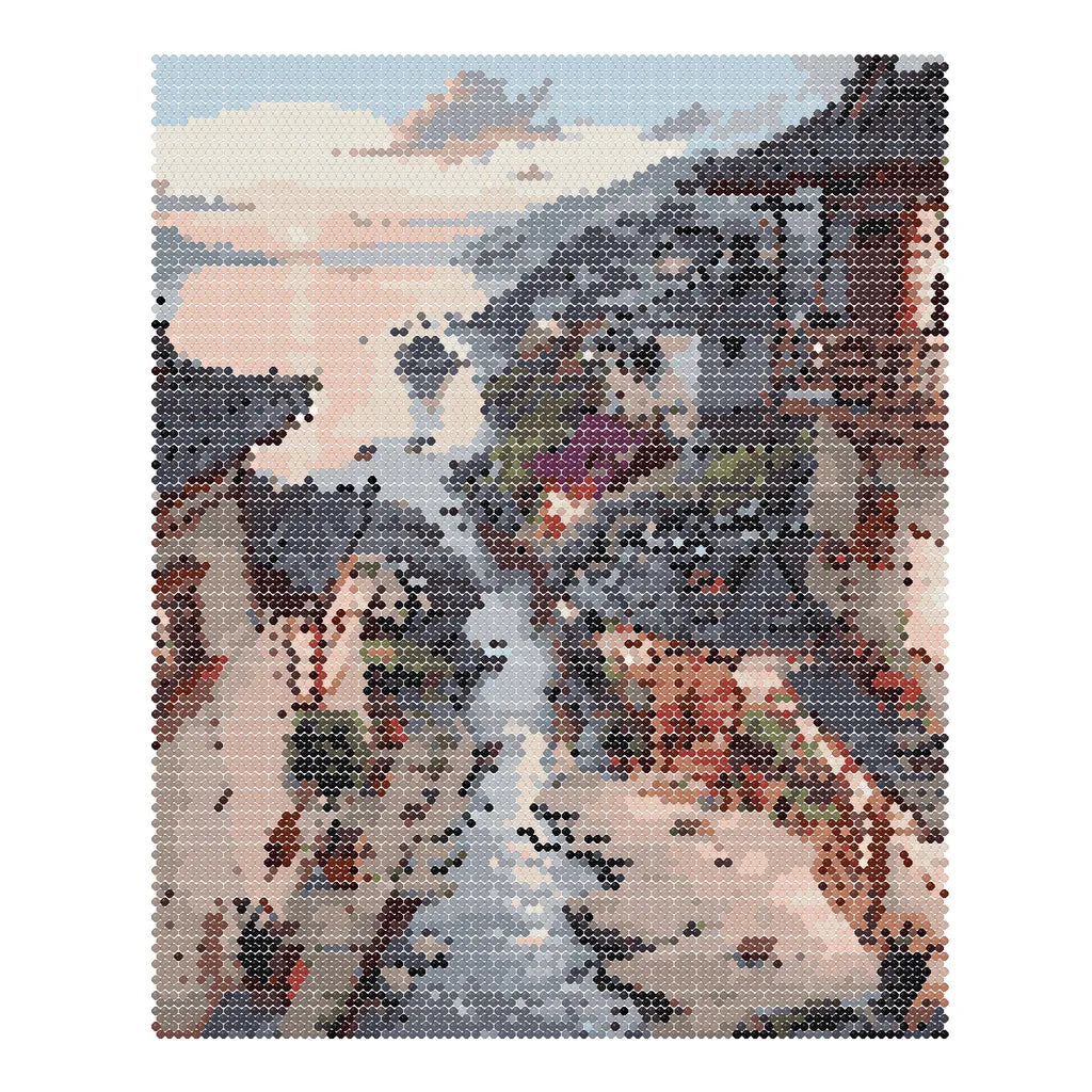Finished diamond painting of traditional riverside village homes reflected along a stream beneath sunset clouds.