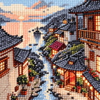 Close-up of drill texture and color in traditional riverside village homes reflected along a stream beneath sunset clouds.