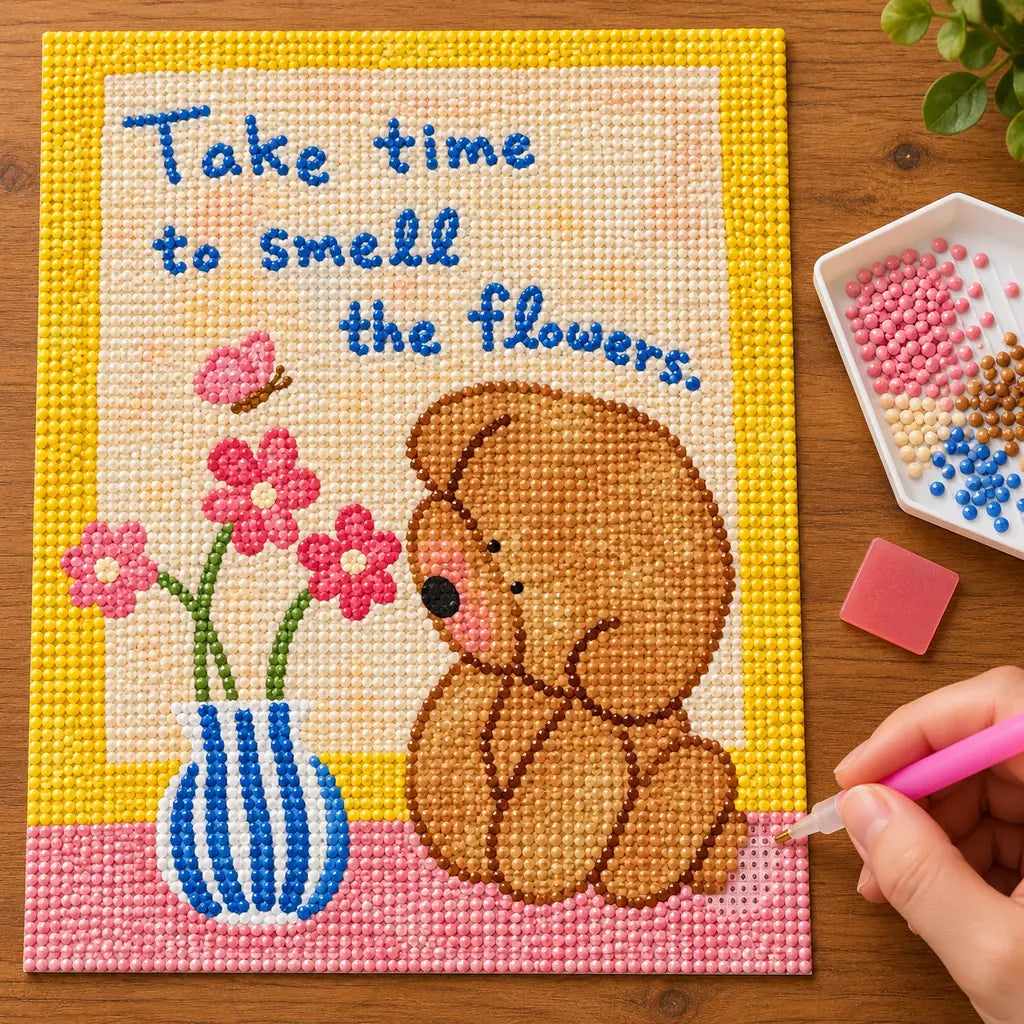 Diamond painting process showing the bear and flower message artwork being completed with a stylus