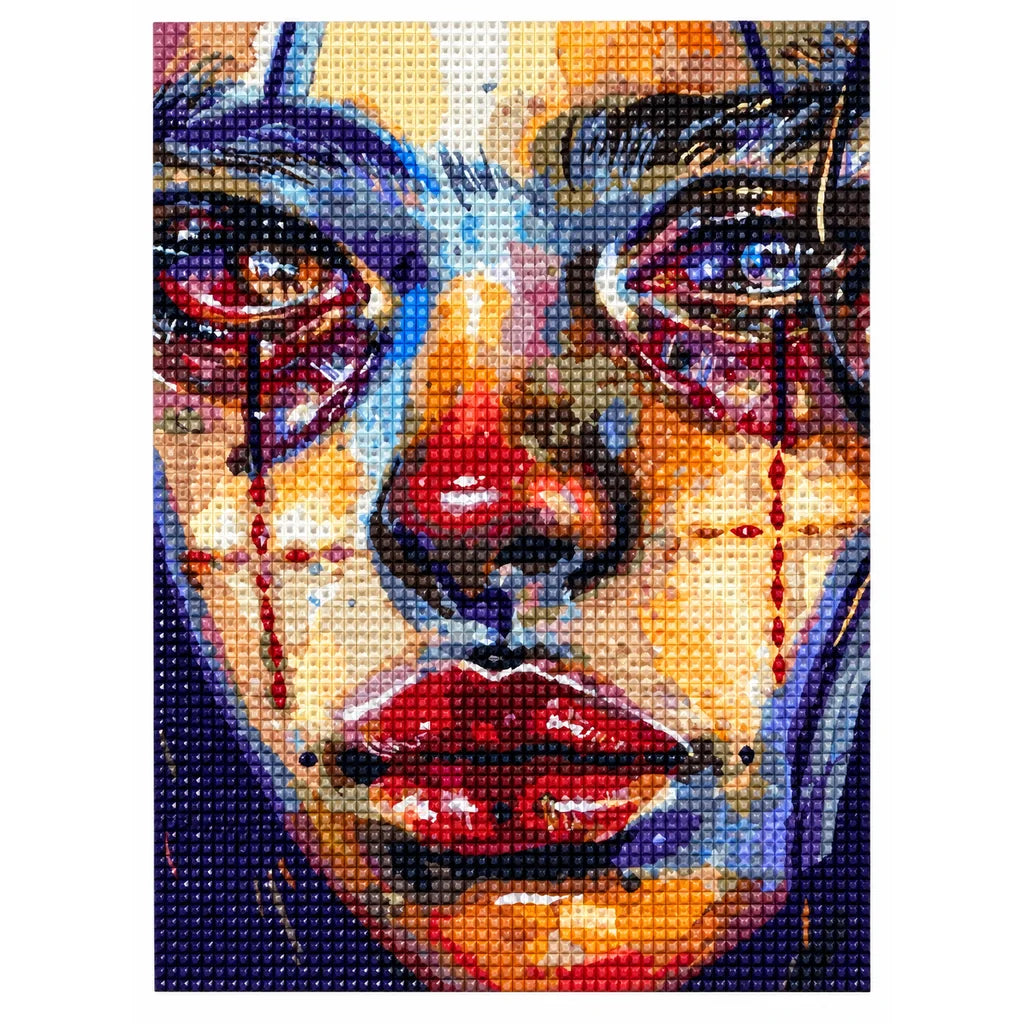 Finished diamond painting of a tear-streaked cubist woman portrait in vivid colors.