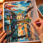 Hands placing diamond drills while working on the Tranquil Village Canal diamond painting.