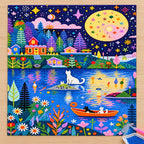 Diamond painting process showing cats in boats on a moonlit village lake being completed with a stylus