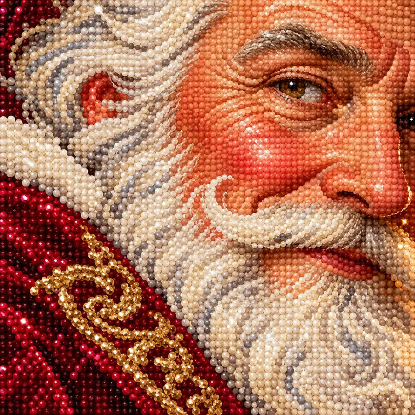Close-up diamond drill detail of a white-bearded Santa in a burgundy Victorian coat beside a candlelit interior artwork