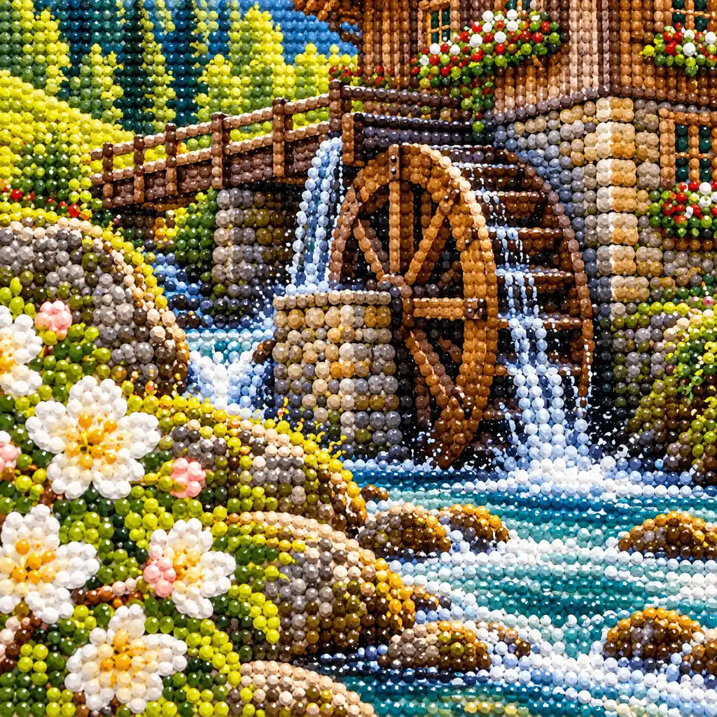 Close-up detail of drills forming white blossoms, flowing water and the mill wheel.